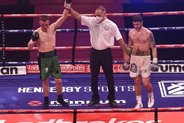 Brett McGinty has his hand raised after his pro debut victory over Jan Ardon. Photo by Hennessy Sports.