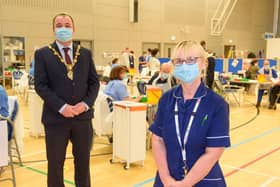 Sylvia Crawford who is one of the retired WHSCT staff who has answered the call to help deliver the Covid-19 vaccine pictured with  Councillor Brian Tierney, Mayor of  Derry City and Strabane District Council, when he visited the   Covid -19 mass vaccination centre in the Foyle Arena. Picture Martin McKeown. 28.01.21