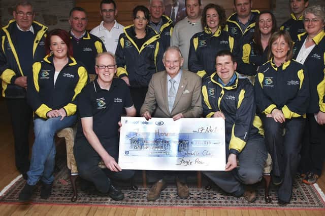 2011: Dr. Tom McGinley, receiving a cheque for €10,210.00 from Foyle Rowing Club Moville members, during the Colmcille Challenge. Local people have organised thousands of fundraisers down the years to support the hospice.