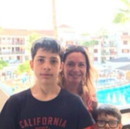Kian with his mum Christine and little brother Evan on holidays before his condition worsened.