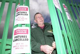 LOCKED OUT  . . . Derry City groundsman Colm Curran locks the gates of  the Brandywell Stadium following the cancellation of City’s home fixture against UCD due to the foot & mouth outbreak
