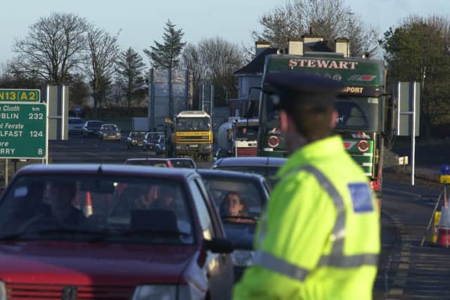 A member of the Garda looks on as traffic queues get longer at border crossing following the worsening of the Foot and Mouth crisis.