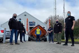 Seamus, pictured at the far back, sets off yesterday. He is supported by his RNLI colleagues.