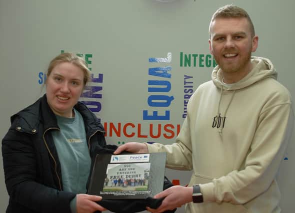 Gavin Melly and Participant Meabh Fisher presenting 32 photo book and hoodie for completing the project