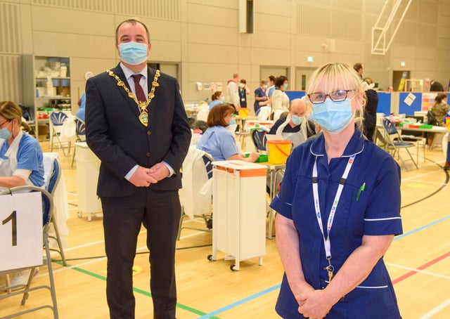 Sylvia Crawford who is one of the retired WHSCT staff who has answered the call to help deliver the Covid-19 vaccine pictured with Councillor Brian Tierney, Mayor of Derry City and Strabane District Council, when he visited the Covid -19 mass vaccination centre in the Foyle Arena. Picture Martin McKeown. 28.01.21