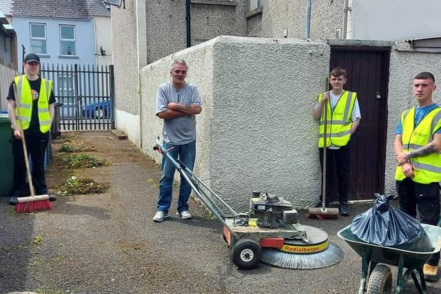 Local Glen Development Initiative team clearing out one of the lanes in the area with residents.