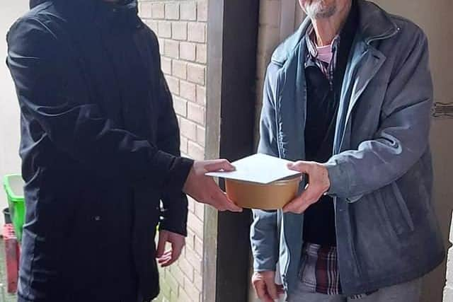 Adrian Kelly, manager of Glen Development Initiative, on left, with a local resident.