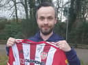 Supporter Colin O’Kane receives a signed Derry City jersey for a raffle he had organised.