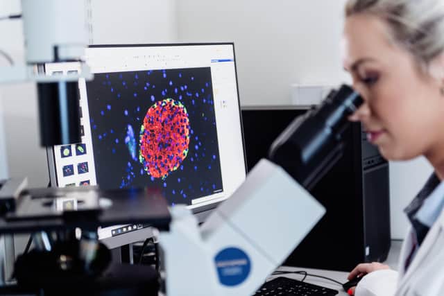 Diabetes researcher using a microscope at Ulster Universityâ€TMs Centre for Molecular Biosciences.  (Photo: Nigel McDowell/Ulster University)