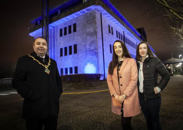 OVARIAN CANCER AWARENESS.. . . . . .The Mayor of Derry City and Strabane District Council, Brian Tierney pictured with Ovarian Cancer campaigner Natalie Cairns and her sister Angela at the Council Offices, Strand Road on Monday night which was lit up to raise awareness of Ovarian Cancer.