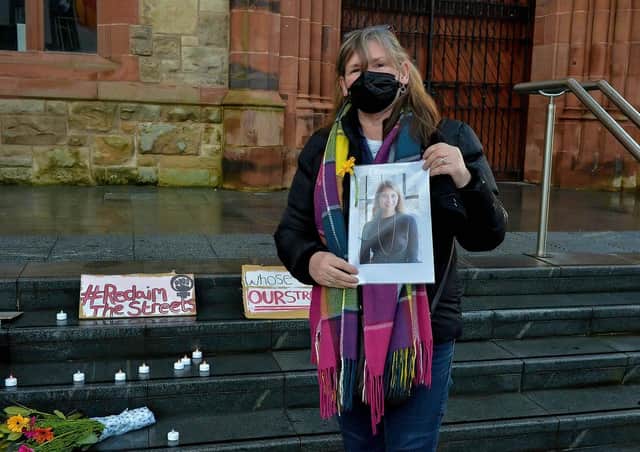 Anita Villia,from Alliance for Choice, holds a photograph of Sarah Everard at the Guildhall steps on Saturday evening last. DER2110GS â€“ 110