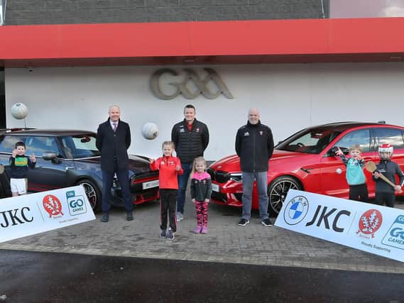From left, Niall MacFlynn (JKC BMW), Derry County Chairperson, Stephen Barker, and County Secretary, Sean Keane with young players at the official announcement of JKC as the official partner of the 2021 Derry Go Games programme.