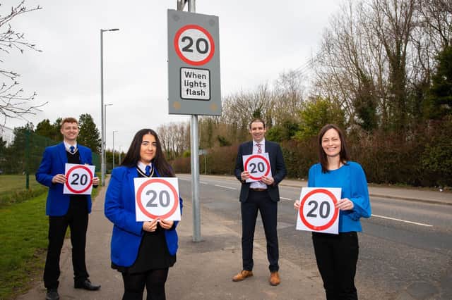 Pupils and a school principal join Infrastructure Minister Nichola Mallon (on right) to announce the new speed limits outside schools across NI.