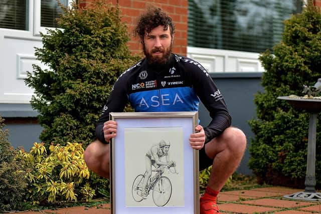 Danny Quigley, who will complete 10 ironman triathlons in 10 days, in memory of his late father, raising funds for suicide awareness pictured with a sketch of his dad. Photo: George Sweeney. DER2112GS - 003