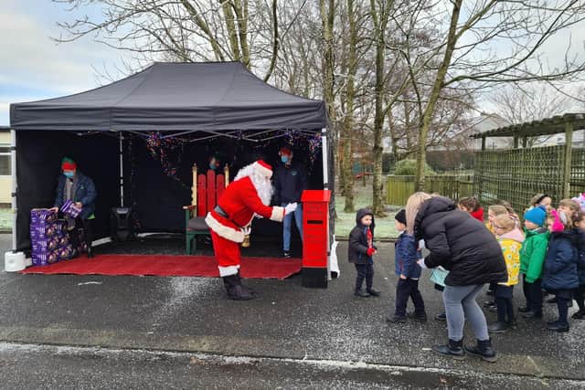 Local children meeting Santa outdoors in the run up to Christmas.