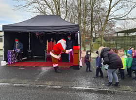 Local children meeting Santa outdoors in the run up to Christmas.
