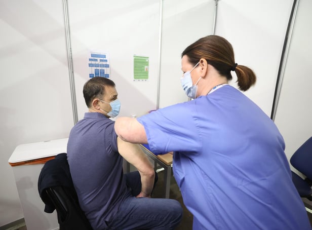 Gary Davidson (left), 55, from Lisbane in Co Down, is the first to receive the AstraZeneca vaccine from Nurse Susan McComisky at the newly opened Covid-19 vaccination centre in the SSE Arena, Belfast on Monday.