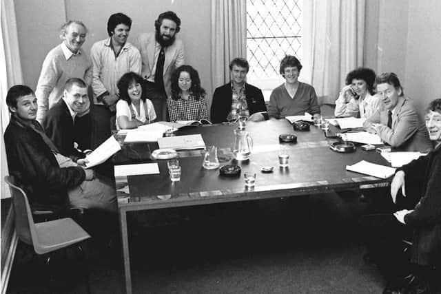 Brian Friel (standing, far left) pictured during a read through of 'Translations' in the Guildhall in Derry in 1980. Included, from left, are actors Liam Neeson and Stephen Rea (seated, furthest left), BAFTA award winning actor, Ray McAnally (third from right) and well known Irish actor Mick Lally (far right). (Copyright: The Derry Journal).