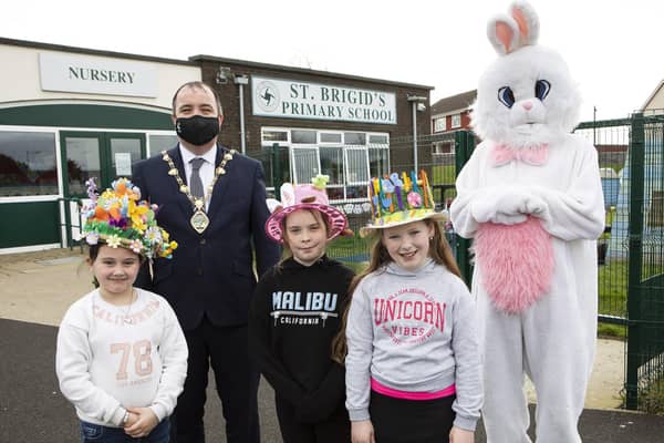 Mayor Brian Tierney with the Easter Bunny prize winner Hannah Browse (centre) a pupil at St. Brigid's PS. Also included are Year 4 class Easter bonnet winners Grace Campbell and, on right, Jenna McShane. ?