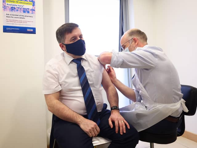 Press Eye - Belfast - Northern Ireland - 31st March 2021Swann receives Covid-19 vaccine and urges public do same Health Minister Robin Swann received his first Astra Zeneca vaccine today at a community pharmacy in Ballymena.He is pictured at the Ballee Pharmacy with pharmacist Stephen Burns. Photo by Kelvin Boyes / Press Eye.