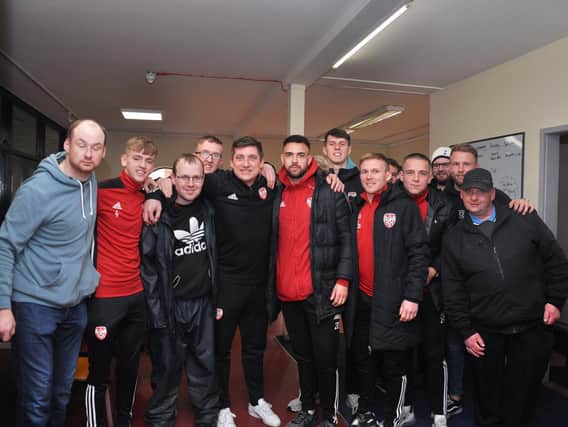 Derry City manager, Declan Devine, Ciaron Harkin, Darren Cole, Eoin Toal, Conor McCormack, Jack Malone and Tim Nilsen pictured with members of Destined during a recent visit to their Foyle Road premises which were vandalised last weekend.