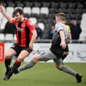 Crusaders midfielder Philip Lowry gets away from Institute's Brendan McLaughlin.