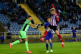 Waterford keeper, Brian Murphy comes to claim this ball under pressure from Derry City striker, Tim Nilsen.