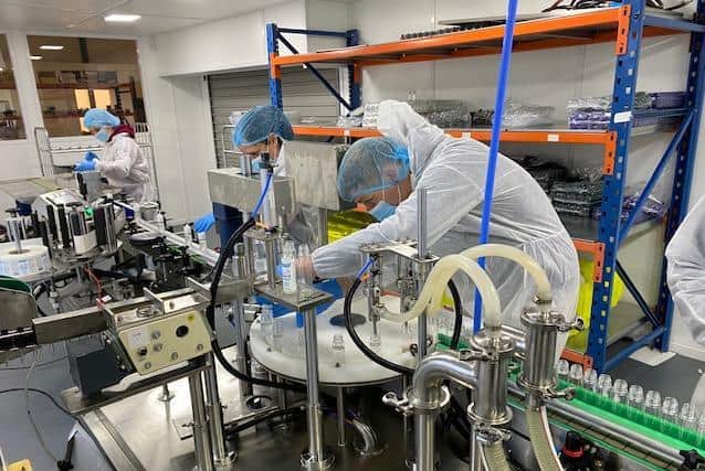 Workers operating the new production line at Liquid Creations.
