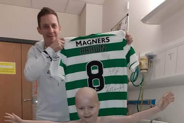 A delighted Ace as his dad, Brian shows off Scott Brown's signed jersey.