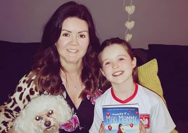 Author Joanne Henry with her daughter Hannah and her new book, Memoirs of a Mad Mammy.