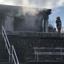 Firefighters finish putting out the latest fire at Sion CC's Clubhouse.