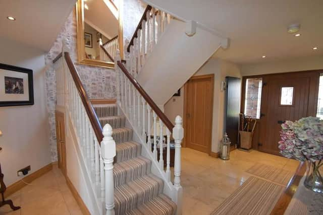 The entrance hall with turning staircase leading to first floor