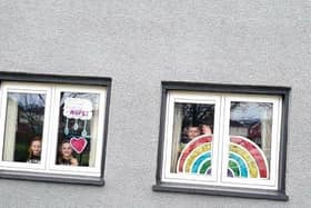 Clodagh, Aobheann and Shea O'Mora with the rainbows of hope they created for their Creggan home