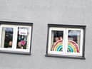 Clodagh, Aobheann and Shea O'Mora with the rainbows of hope they created for their Creggan home