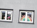 Clodagh, Aobheann and Shea O'Mora with the rainbows of hope they created for their Creggan home