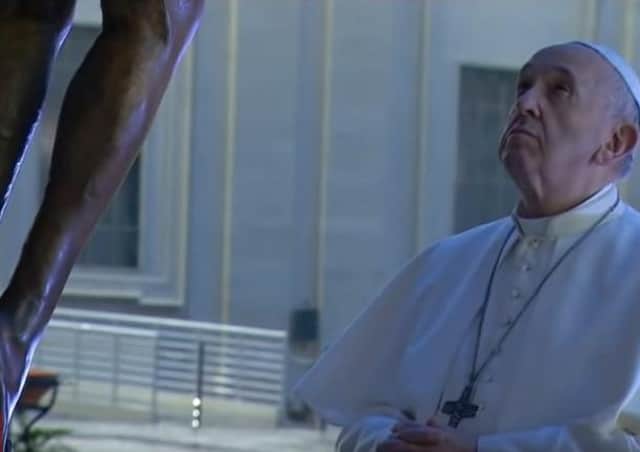 Pope Francis prays at the foot of the Cross outside St Peter's Basilica in the Vatican City. (Picture Vatican Media YouTube)
