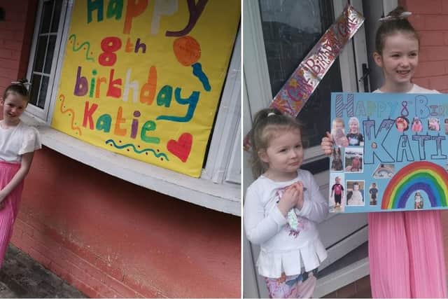 Katie Francis-Lynott, pictured with her little sister Roma, with some of the birthday banners made by the family.