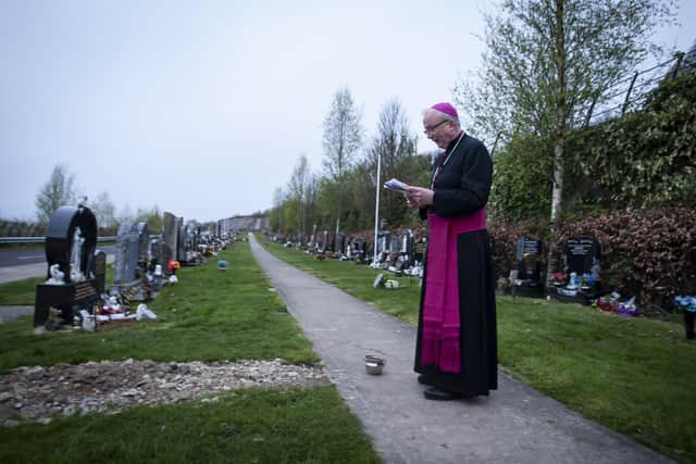 Bishop of Derry, Dr. Donal McKeown pictured at the City Cemetery in Derry on Easter Sunday morning blessing graves with Easter Water that was blessed at St. Eugeneâ€TMs Cathedral during the Vigil Mass on Saturday night. (Photos: jim McCafferty Photography)