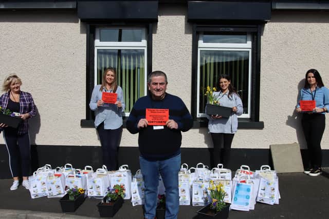 Peter McDonald (front) with members of the Ballyarnett Community Support team ready to deliver the red cards and support packs.