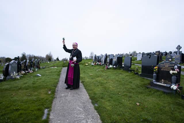 Bishop of Derry, Dr. Donal McKeown pictured at the City Cemetery in Derry on Easter Sunday morning blessing graves with Easter Water that was blessed at St. Eugeneâ€TMs Cathedral during the Vigil Mass on Saturday night. (Photos: jim McCafferty Photography)