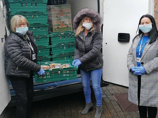 Ciara Ferguson and her team from Greater Shantallow Area Partnership (GSAP) unpack the Fareshare food being delivered by Apex Housing Association to distribute amongst local families.