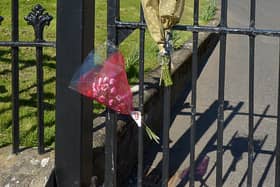 Flowers placed at the endurance to the City Cemetery which remains closed to the public. DER1720GS - 008