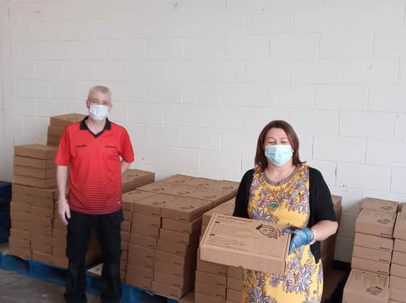 Mayor of Derry City and Strabane District Council, Councillor Michaela Boyle, receiving PPE equipment from Niall Diamond, Director, Diamond Corrugated.