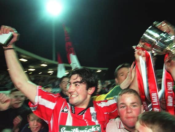 Derry City captain, Peter Hutton parades the trophy at Brandywell.