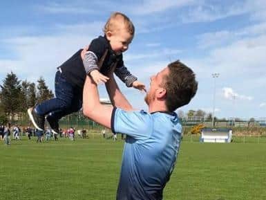 Eamonn celebrates Institutes title win with his son, Ethan in 2018.