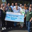 2019 - Dr Zahid front left with other members of the North West Islamic Association pictured after last year’s Ramadan fast challenge presenting the proceeds to James McMenamin, on the right, manager of the Foyle Foodbank. DER2619GS-055