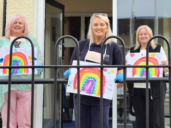 Housing Executive Patch Manager Paula Maguire (left) and Neighbourhood Officer Karly King, pictured with Central Housing Forum Chair Linda Watson (right), distributing essential supplies to tenants in Derry.