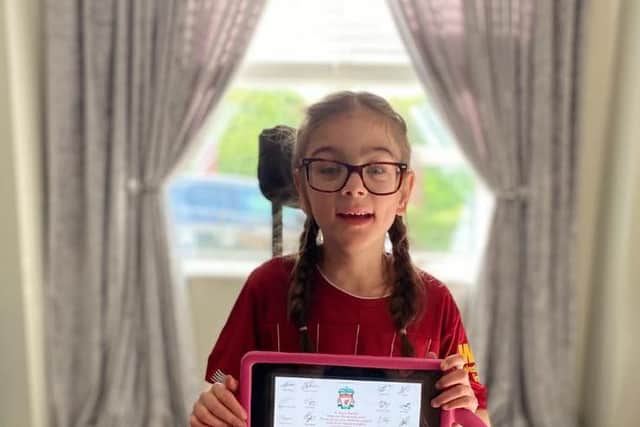 Grace, aged 8, received a signed certificate from Liverpool manager, Jurgen Klopp and the star-studded Liverpool team.