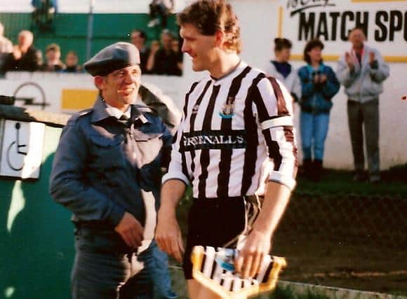 Newcastle captain, Roy Aitken makes his way onto the Brandywell pitch.