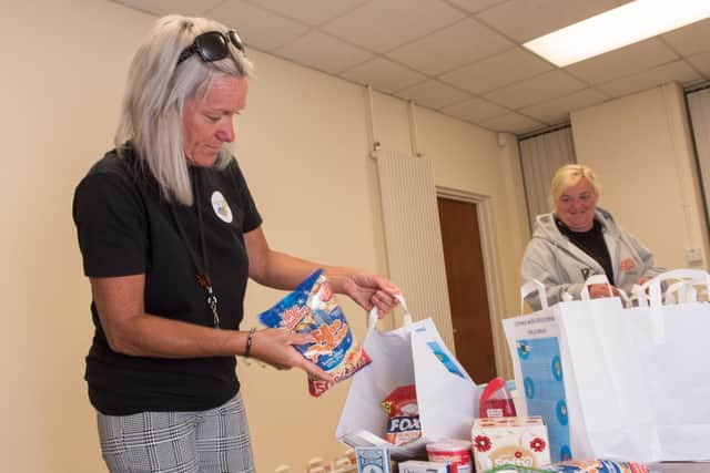 Michelle McAdams from Ballyarnett Coummunity Support Team redistributes some of the food boxes for residnets of the local area. Picture Martin McKeown. 07.05.20